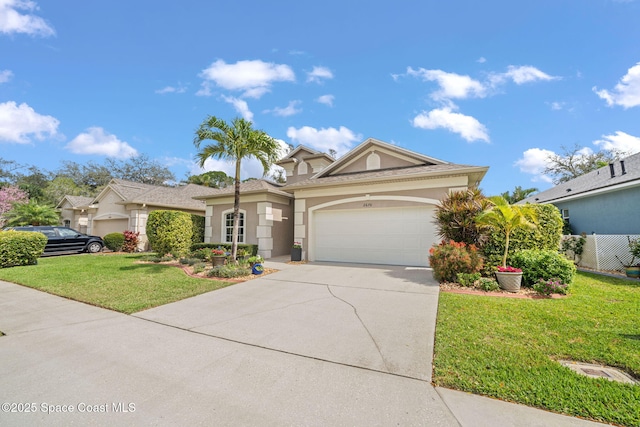 view of front of house featuring an attached garage, driveway, a front yard, and stucco siding