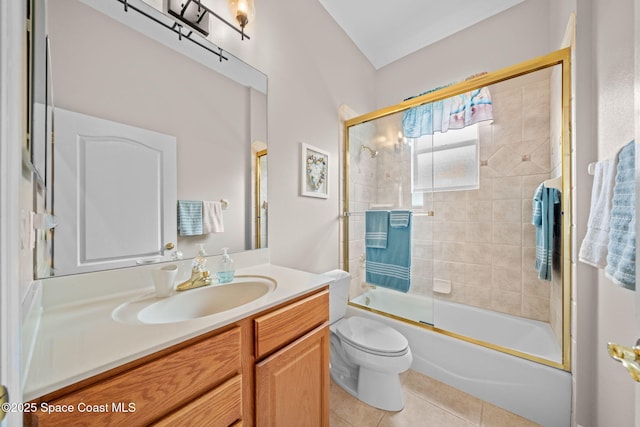 bathroom featuring toilet, shower / bath combination with glass door, tile patterned flooring, and vanity