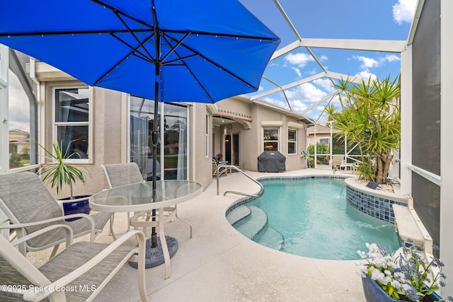 pool featuring glass enclosure, a grill, and a patio