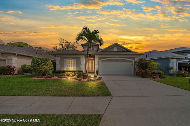 view of front of home with a garage, concrete driveway, a lawn, and stucco siding