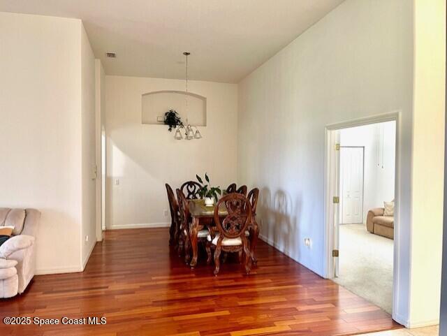 dining space with visible vents and wood finished floors