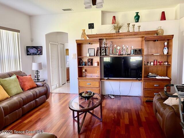 1401 Rila St SE, Palm Bay, FL 32909 - living room with visible vents, arched walkways, and wood finished floors