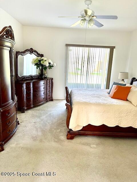 1401 Rila St SE, Palm Bay, FL 32909 - bedroom featuring ceiling fan, access to outside, and light colored carpet