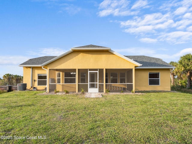 back of property with a shingled roof, a sunroom, a yard, central AC, and stucco siding