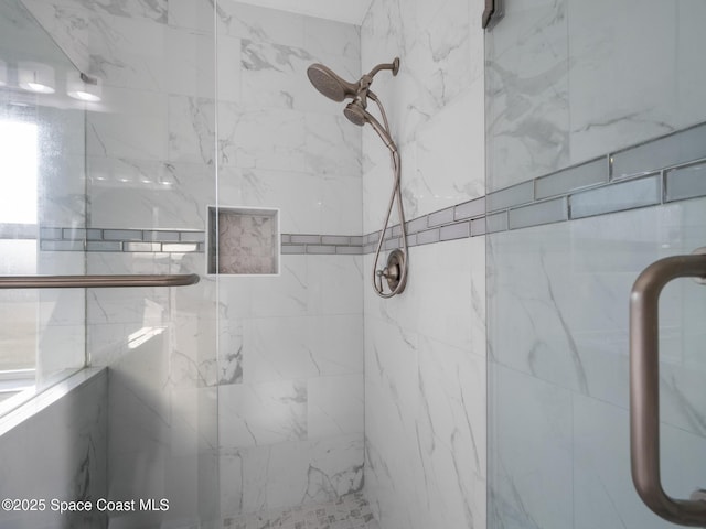 full bath with a marble finish shower