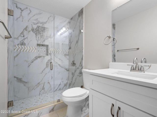 bathroom featuring toilet, vanity, and a marble finish shower