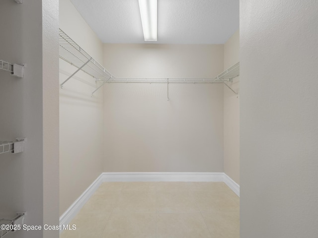 walk in closet featuring light tile patterned floors