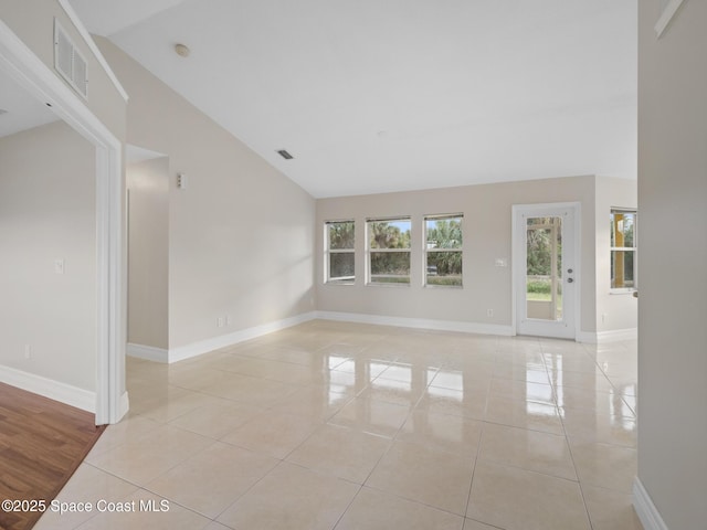 spare room featuring light tile patterned floors, visible vents, and baseboards