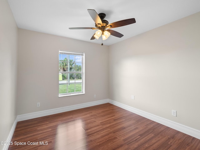 unfurnished room with a ceiling fan, baseboards, and wood finished floors