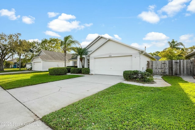 ranch-style house with a garage, concrete driveway, stucco siding, fence, and a front yard