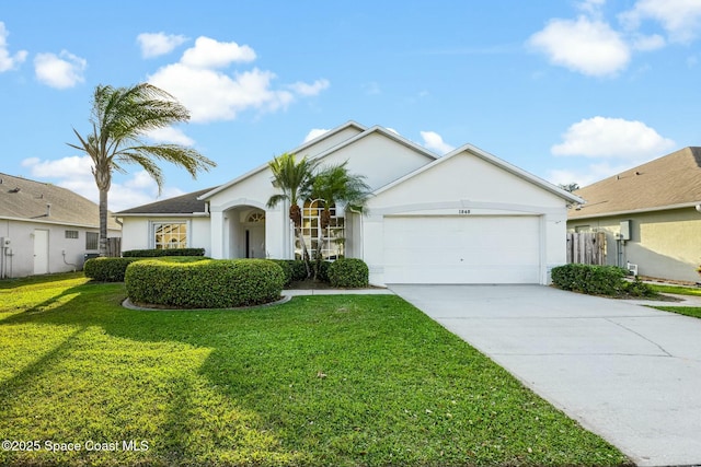 ranch-style home with a garage, a front yard, concrete driveway, and stucco siding