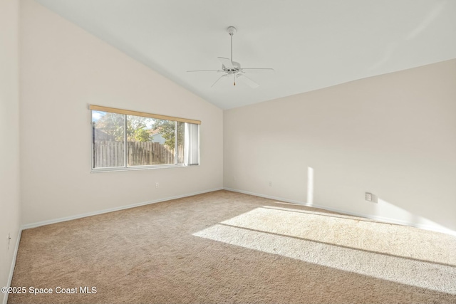 carpeted empty room with lofted ceiling, ceiling fan, and baseboards