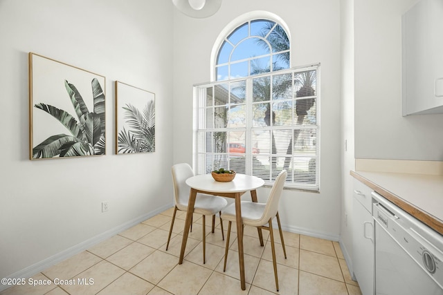 dining area with light tile patterned flooring and baseboards