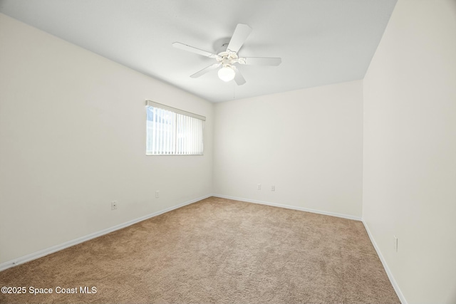 empty room featuring carpet flooring, a ceiling fan, and baseboards