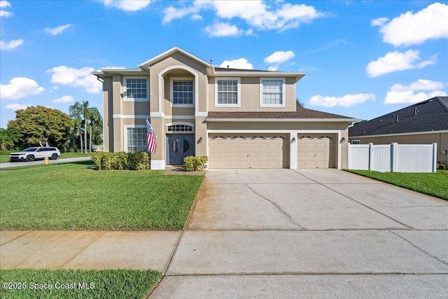 traditional-style home featuring stucco siding, concrete driveway, a front yard, fence, and a garage