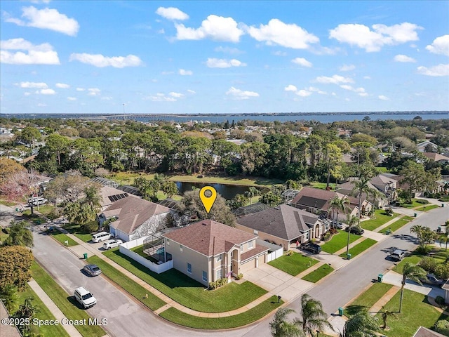 drone / aerial view with a residential view and a water view