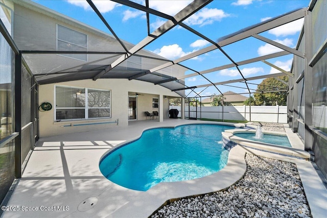 view of pool with a lanai, a pool with connected hot tub, fence, and a patio