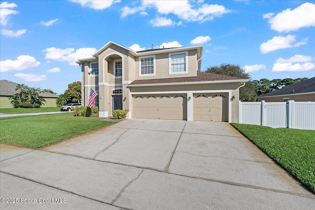 traditional-style home with stucco siding, concrete driveway, an attached garage, a front yard, and fence