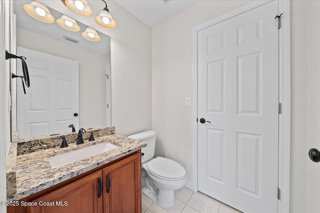 half bath featuring toilet, vanity, tile patterned flooring, and visible vents