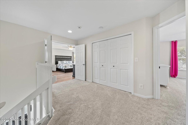 unfurnished bedroom with a closet, baseboards, and carpet flooring