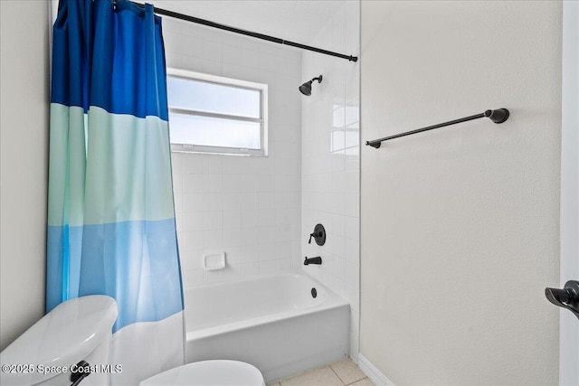 full bath with tile patterned flooring, shower / bath combination with curtain, and toilet