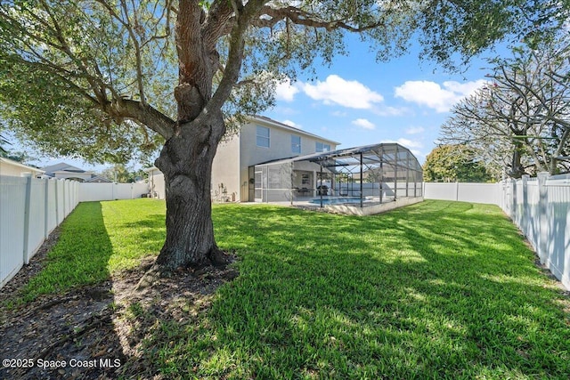 view of yard featuring glass enclosure, a fenced backyard, and a fenced in pool