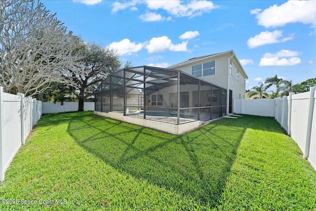 rear view of house with a yard, a fenced backyard, a fenced in pool, and a lanai