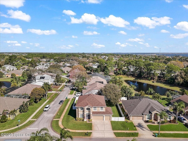 drone / aerial view with a water view and a residential view