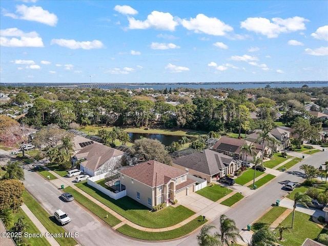 drone / aerial view with a water view and a residential view