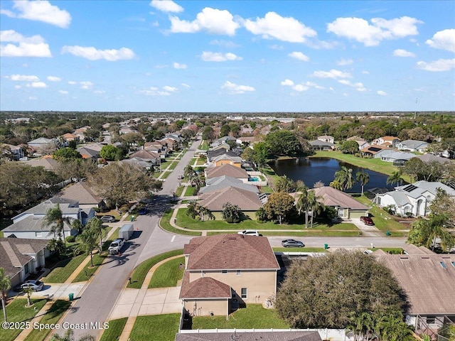 drone / aerial view featuring a water view and a residential view