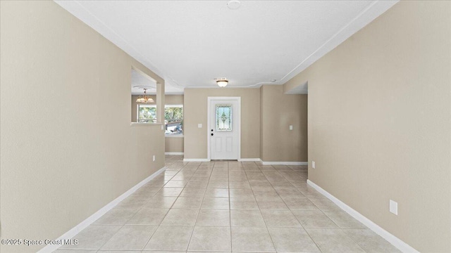 foyer featuring light tile patterned floors and baseboards