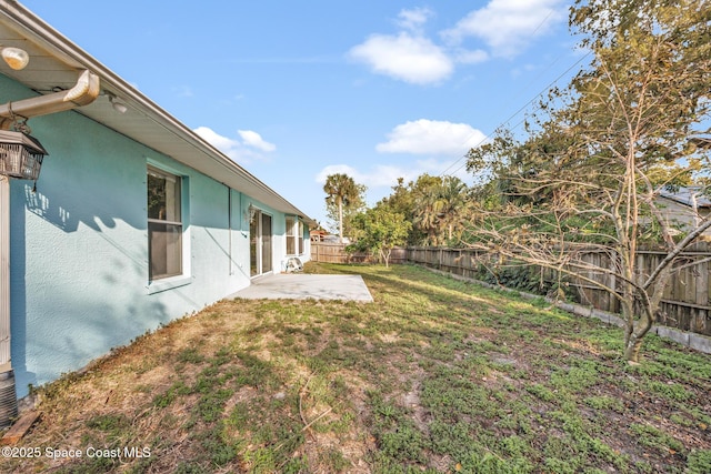 view of yard with a fenced backyard and a patio