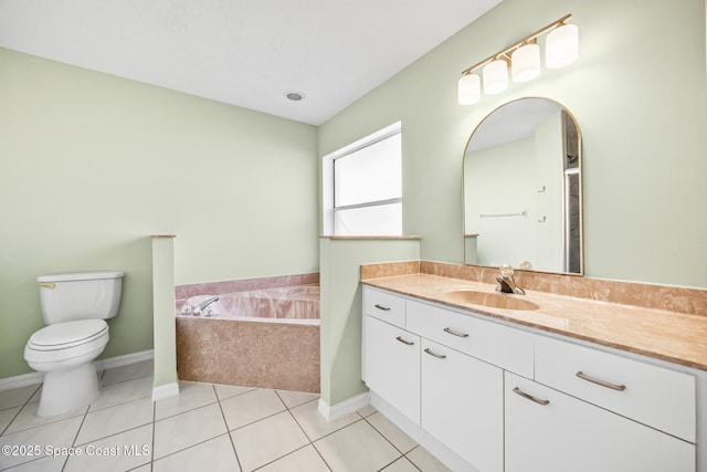 full bath with a garden tub, toilet, vanity, tile patterned flooring, and baseboards