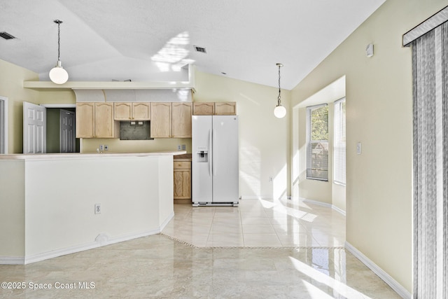 kitchen featuring white refrigerator with ice dispenser, visible vents, hanging light fixtures, vaulted ceiling, and light brown cabinetry