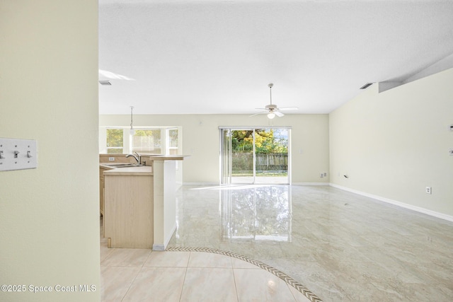 unfurnished room featuring a ceiling fan, baseboards, visible vents, and a sink