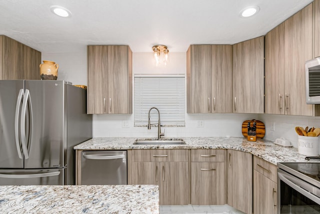 4813 Union Cypress Pl, Melbourne, FL 32904 - kitchen featuring stainless steel appliances, a sink, light stone counters, and light brown cabinets