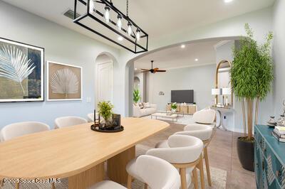 dining area with arched walkways, light tile patterned flooring, ceiling fan, and recessed lighting