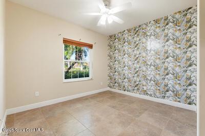 empty room with wallpapered walls and baseboards