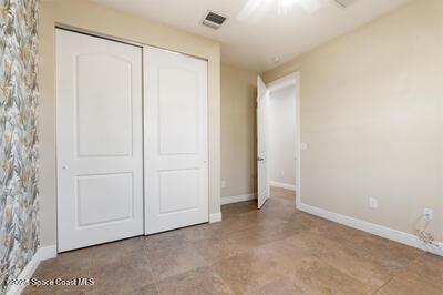 unfurnished bedroom featuring a closet, visible vents, and baseboards