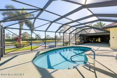 pool featuring a patio area and glass enclosure