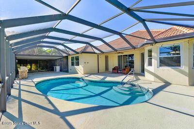 pool featuring a patio area and glass enclosure