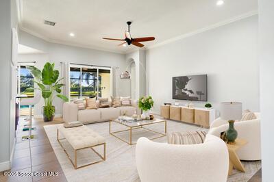 living room featuring a ceiling fan, recessed lighting, tile patterned flooring, and crown molding