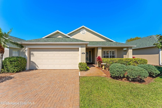 single story home with roof with shingles, decorative driveway, an attached garage, and stucco siding