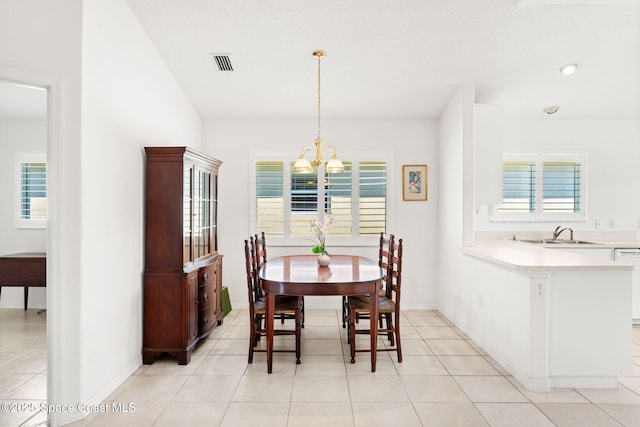 dining space with a chandelier, visible vents, plenty of natural light, and light tile patterned floors