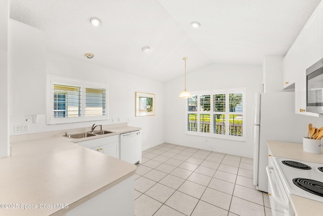 kitchen with lofted ceiling, light countertops, white cabinetry, a sink, and white appliances