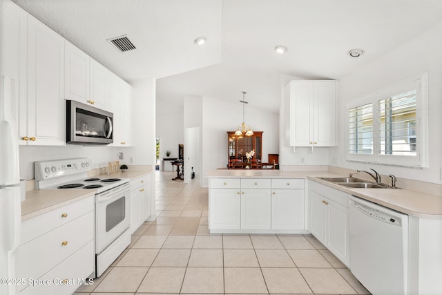 kitchen with light tile patterned floors, white appliances, a sink, visible vents, and vaulted ceiling