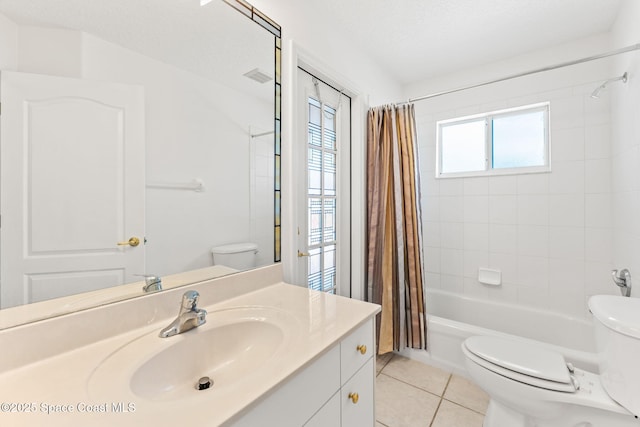 full bath featuring toilet, visible vents, vanity, tile patterned floors, and shower / bath combo with shower curtain