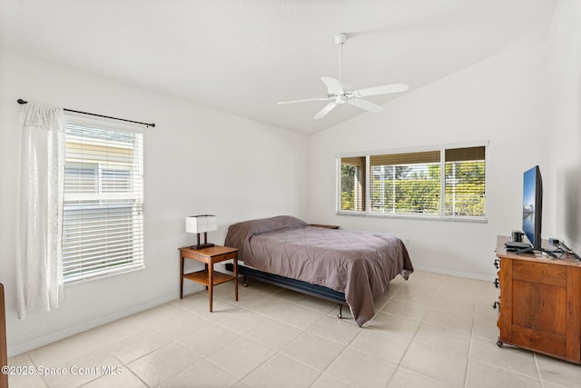 bedroom with lofted ceiling, light tile patterned floors, ceiling fan, and baseboards