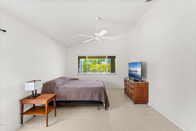 bedroom with lofted ceiling, light tile patterned floors, baseboards, and a ceiling fan