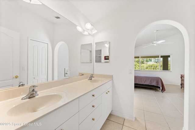 ensuite bathroom featuring ensuite bathroom, tile patterned floors, a sink, and lofted ceiling